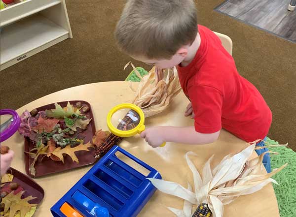 Kids playing with harvest and autumn decor