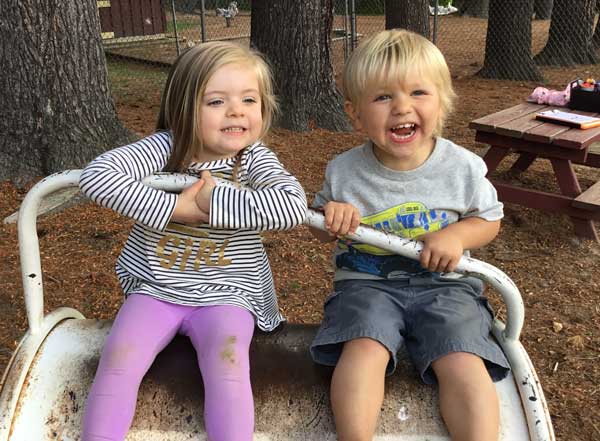 Two toddlers playing in the playground